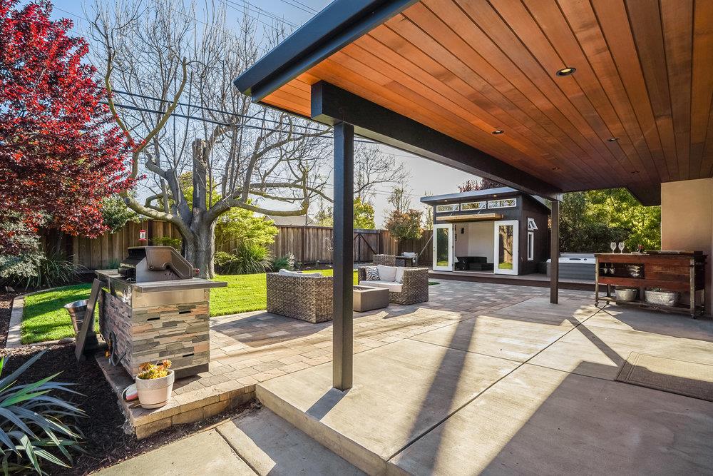 2354 Marr Lane San Jose, CA 95124 - Photo 17 of 55 a view of a patio with table and chairs potted plants and a large tree