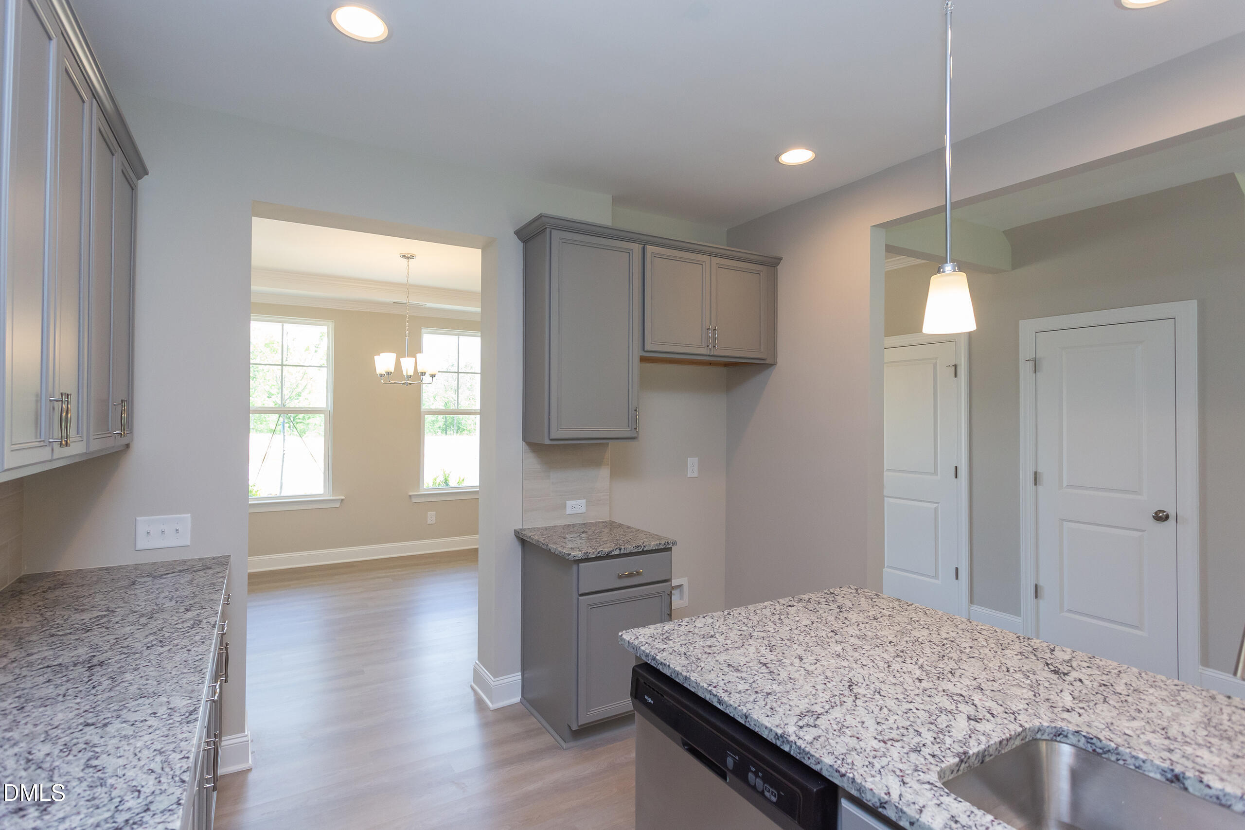 4921 Theater Way, Unit 7 Raleigh, NC 27604 - Photo 11 of 37 a kitchen with kitchen island a sink appliances and cabinets