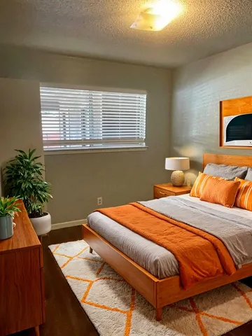 a bedroom with a bed and a potted plant