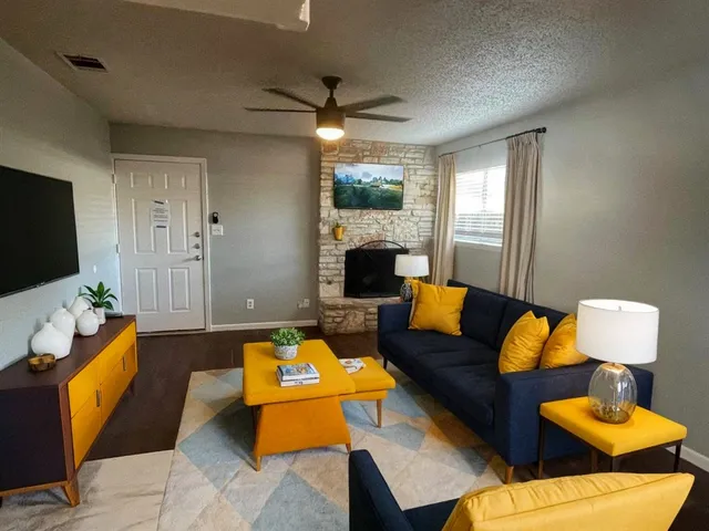 a living room with furniture fireplace and flat screen tv