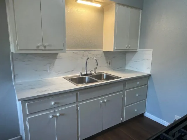 a kitchen with a sink and cabinets