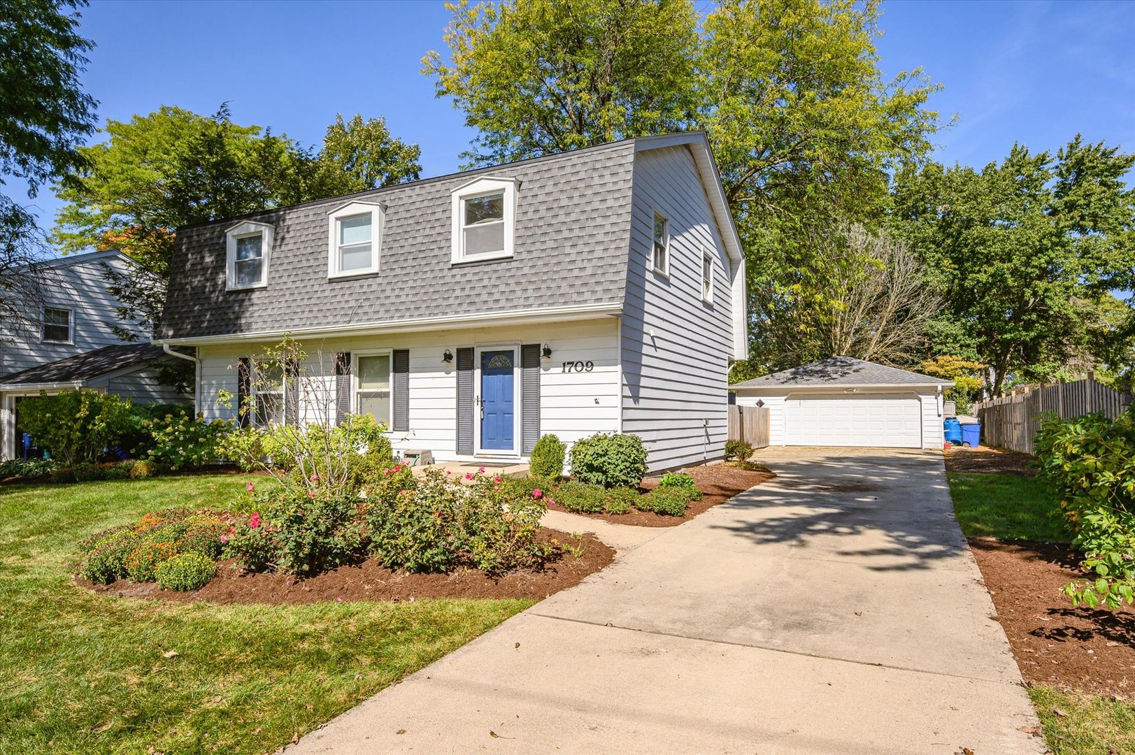 1709 Kay Road Wheaton, IL 60187 - Photo 3 of 37 a front view of a house with a yard and trees
