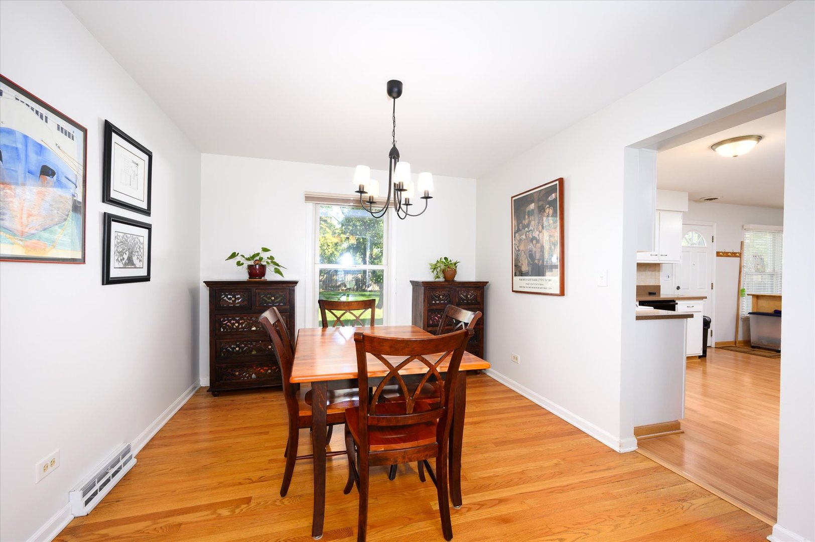 1709 Kay Road Wheaton, IL 60187 - Photo 9 of 37 a dining room with furniture a chandelier and wooden floor