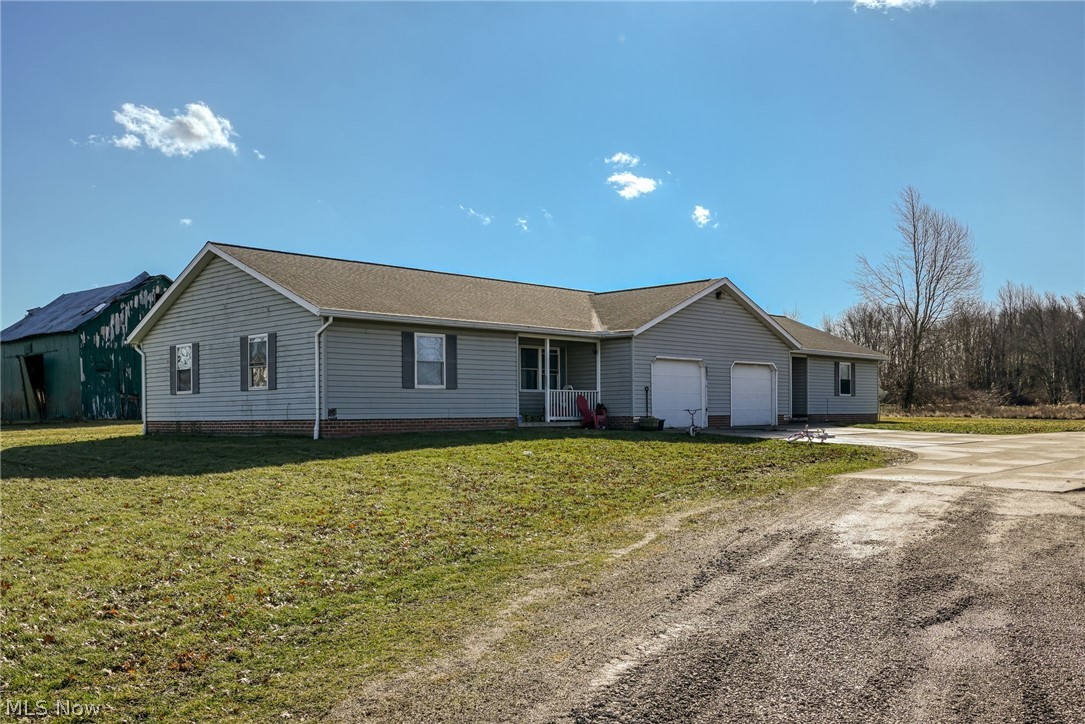 8464-8446 Tallmadge Road Diamond, OH 44412 - Photo 29 of 39 Single story home featuring concrete driveway, an attached garage, a front lawn, and roof with shingles