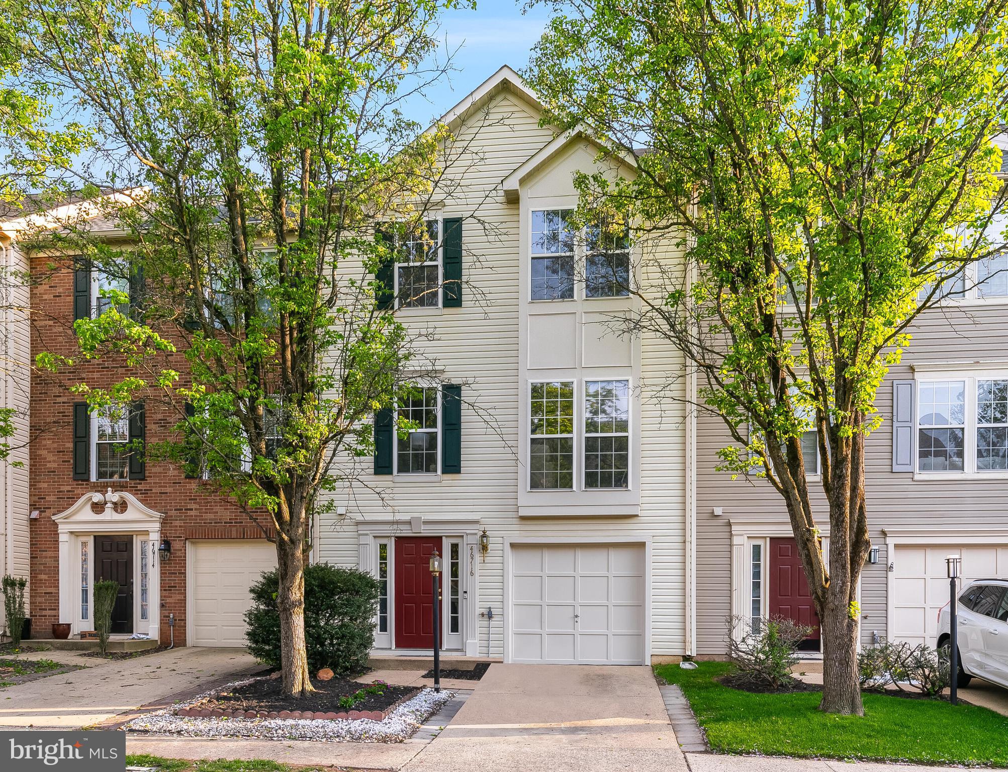 46716 Cavendish Square Sterling, VA 20165 - Photo 1 of 42 a view of a white house with a large tree and windows