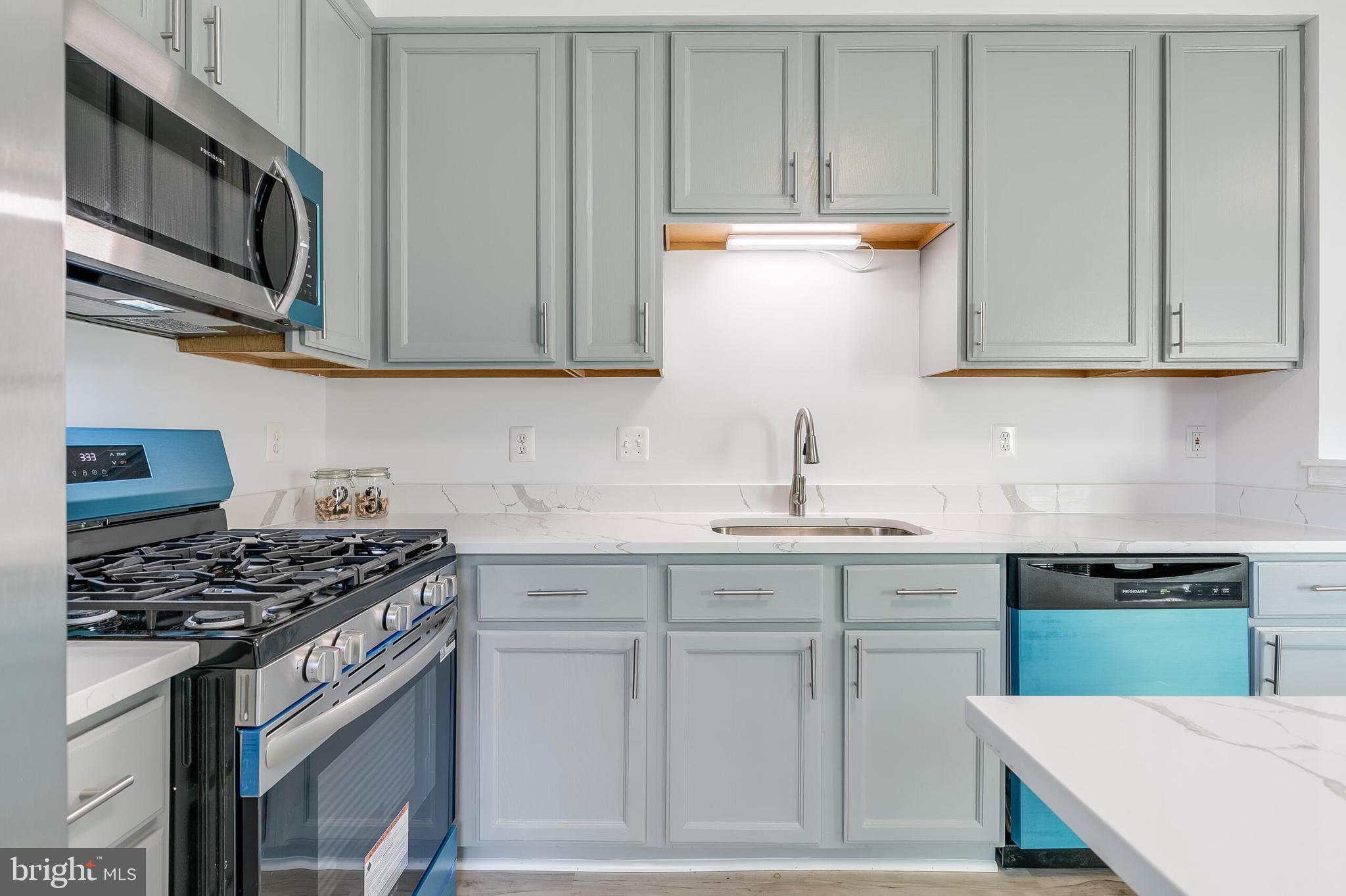 46716 Cavendish Square Sterling, VA 20165 - Photo 11 of 42 a kitchen with stainless steel appliances granite countertop a stove and a sink