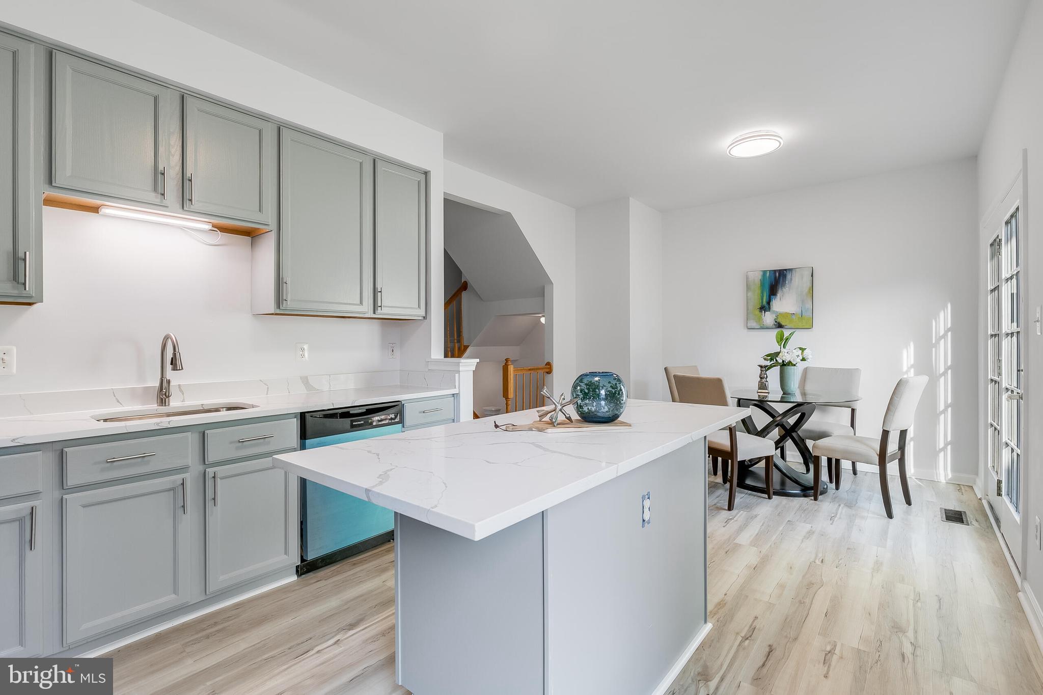 46716 Cavendish Square Sterling, VA 20165 - Photo 12 of 42 a kitchen with a sink a table and chairs in it