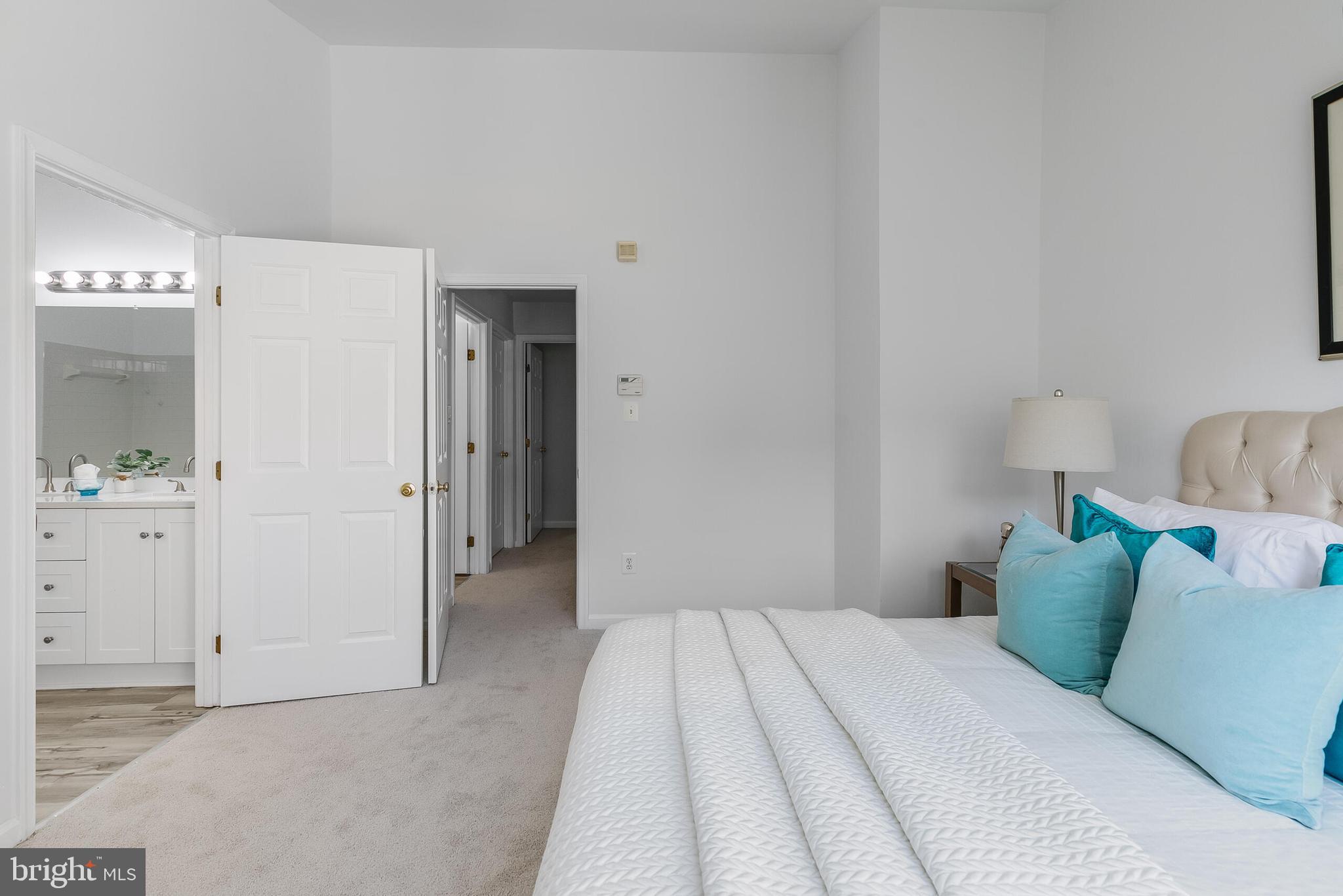 46716 Cavendish Square Sterling, VA 20165 - Photo 19 of 42 a bedroom with a bed and mirror