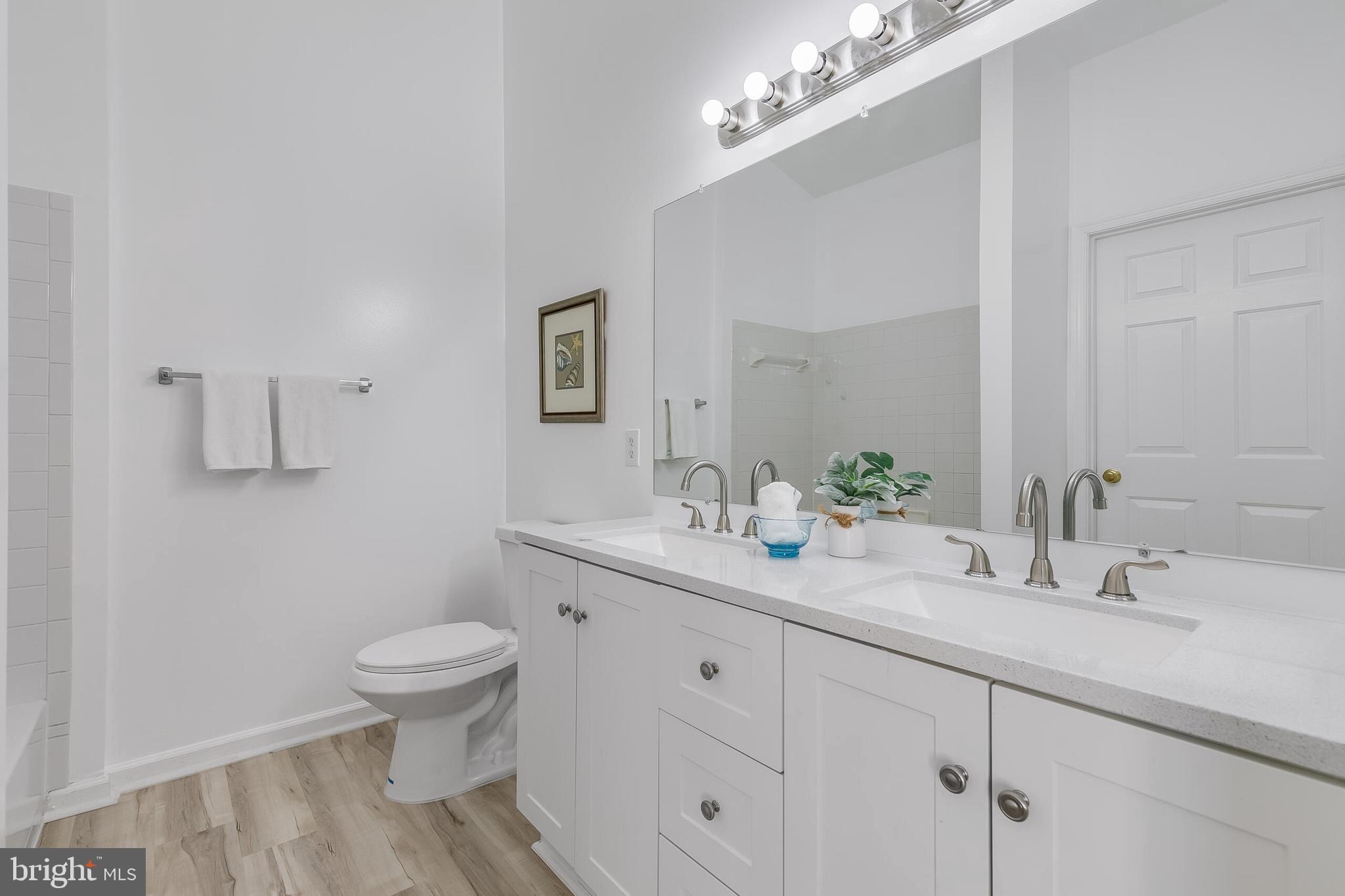 46716 Cavendish Square Sterling, VA 20165 - Photo 20 of 42 a bathroom with a toilet sink and mirror