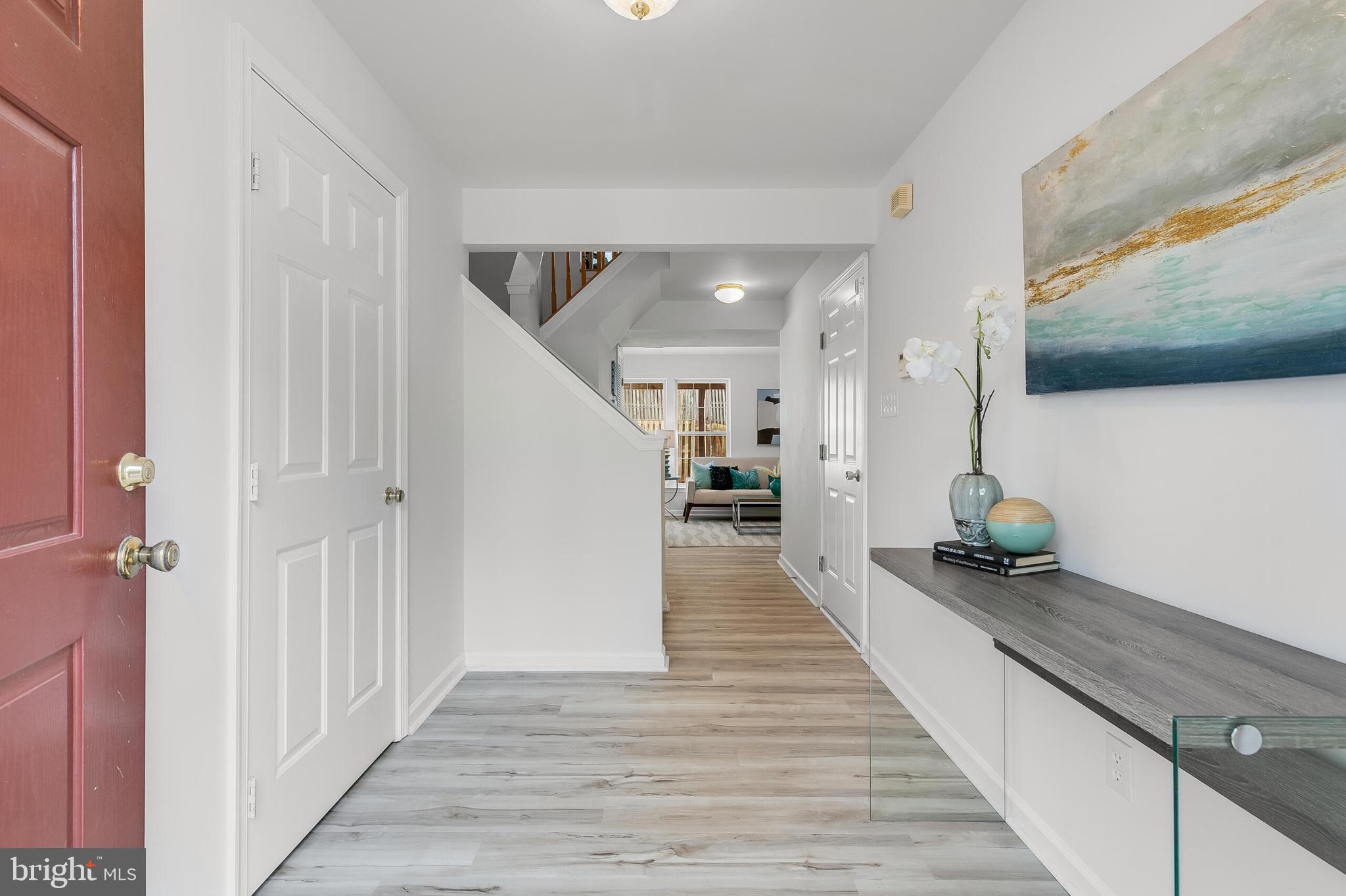 46716 Cavendish Square Sterling, VA 20165 - Photo 2 of 42 a hallway with a view of living room with furniture