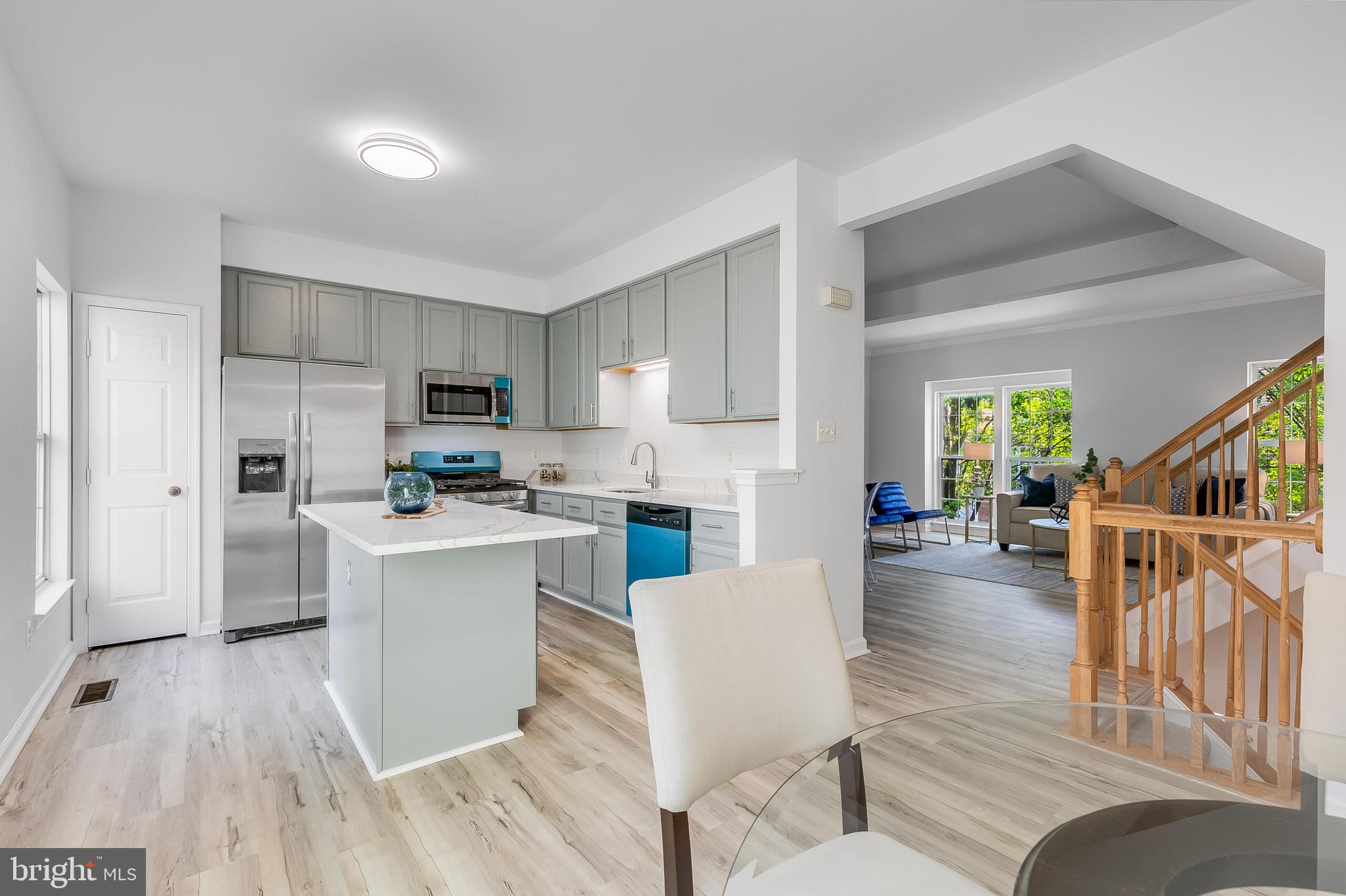 46716 Cavendish Square Sterling, VA 20165 - Photo 10 of 42 a living room with furniture a kitchen island with wooden floors and white walls