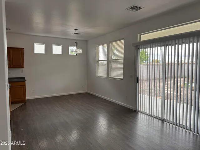 a view of a white house with a sink and yard