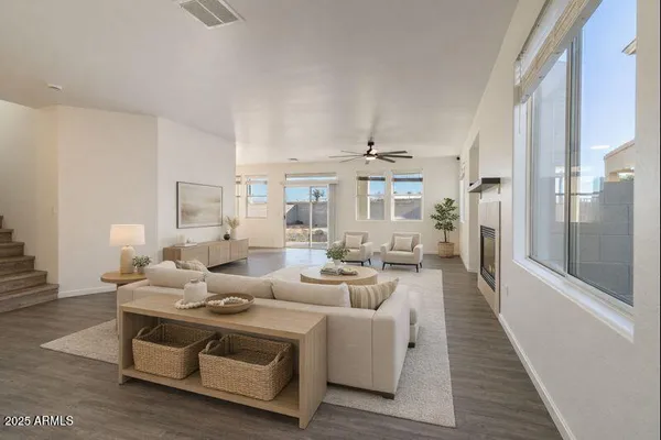 a living room with furniture and a chandelier