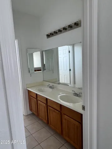 a bathroom with a granite countertop sink mirror and double