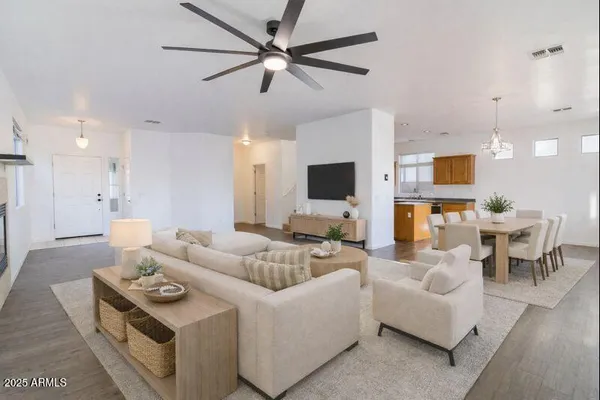 a living room with furniture a fireplace and a flat screen tv