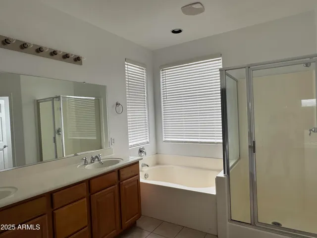 a bathroom with a tub sink and mirror
