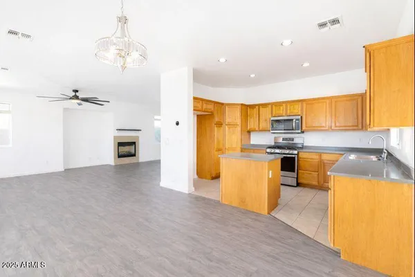 a kitchen with stainless steel appliances a refrigerator a stove top oven a sink and dishwasher