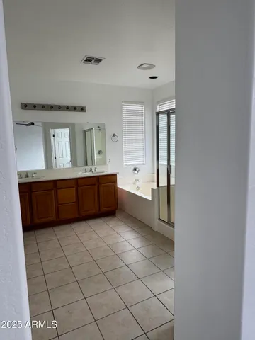 a view of a bathroom with sink and mirror