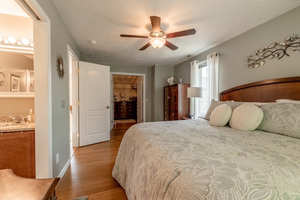 22 Duluth Street Worcester, MA 01604 - Photo 19 of 35 a spacious bedroom with a bed and a chandelier