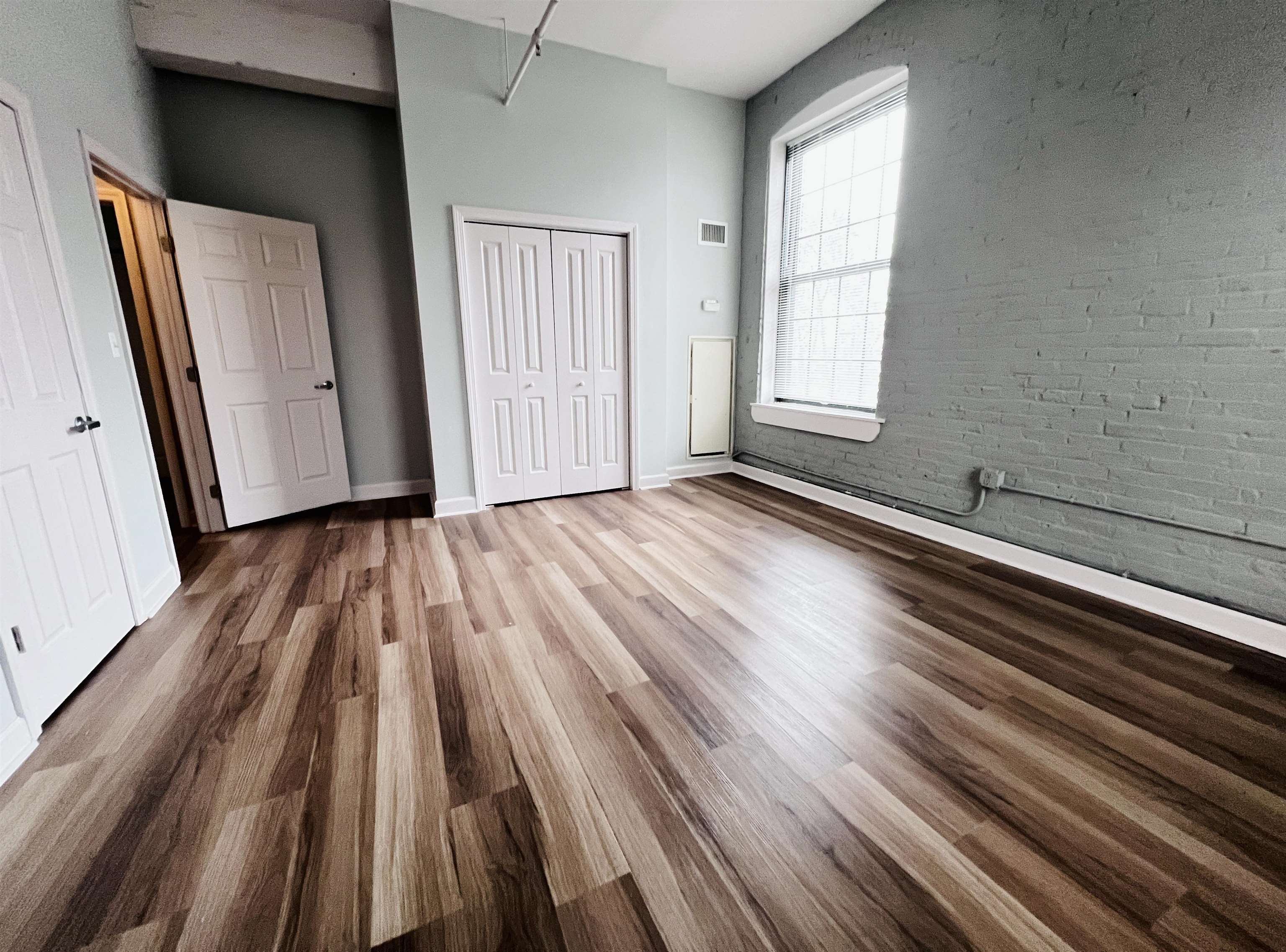 160 Lafayette Street, Unit 52207 Jersey City, NJ 07304 - Photo 2 of 25 a view of a room with wooden floor and window