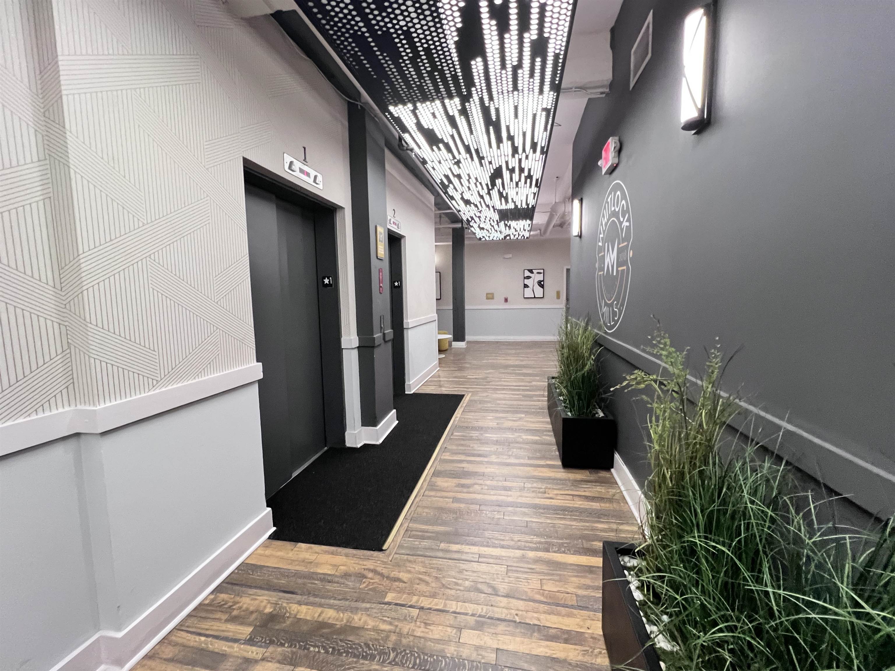 160 Lafayette Street, Unit 52207 Jersey City, NJ 07304 - Photo 24 of 25 a hallway with wooden floor and staircase