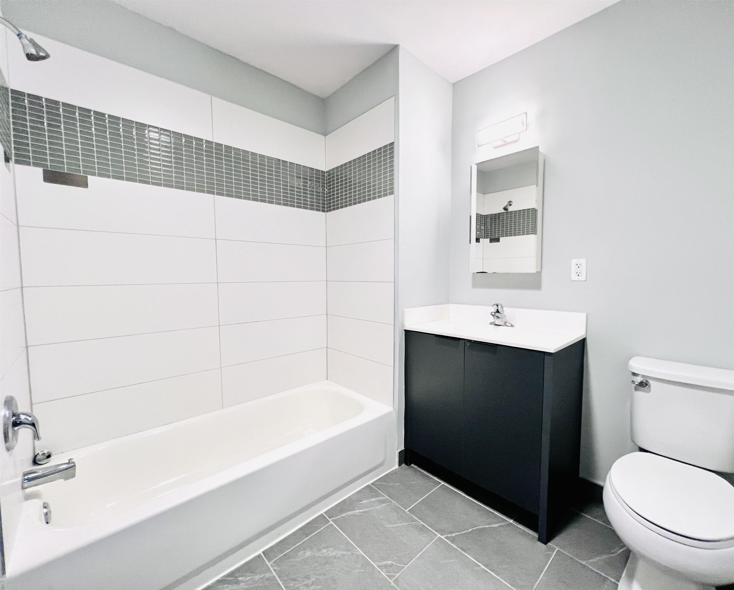 160 Lafayette Street, Unit 52207 Jersey City, NJ 07304 - Photo 4 of 25 a bathroom with a sink toilet and bathtub