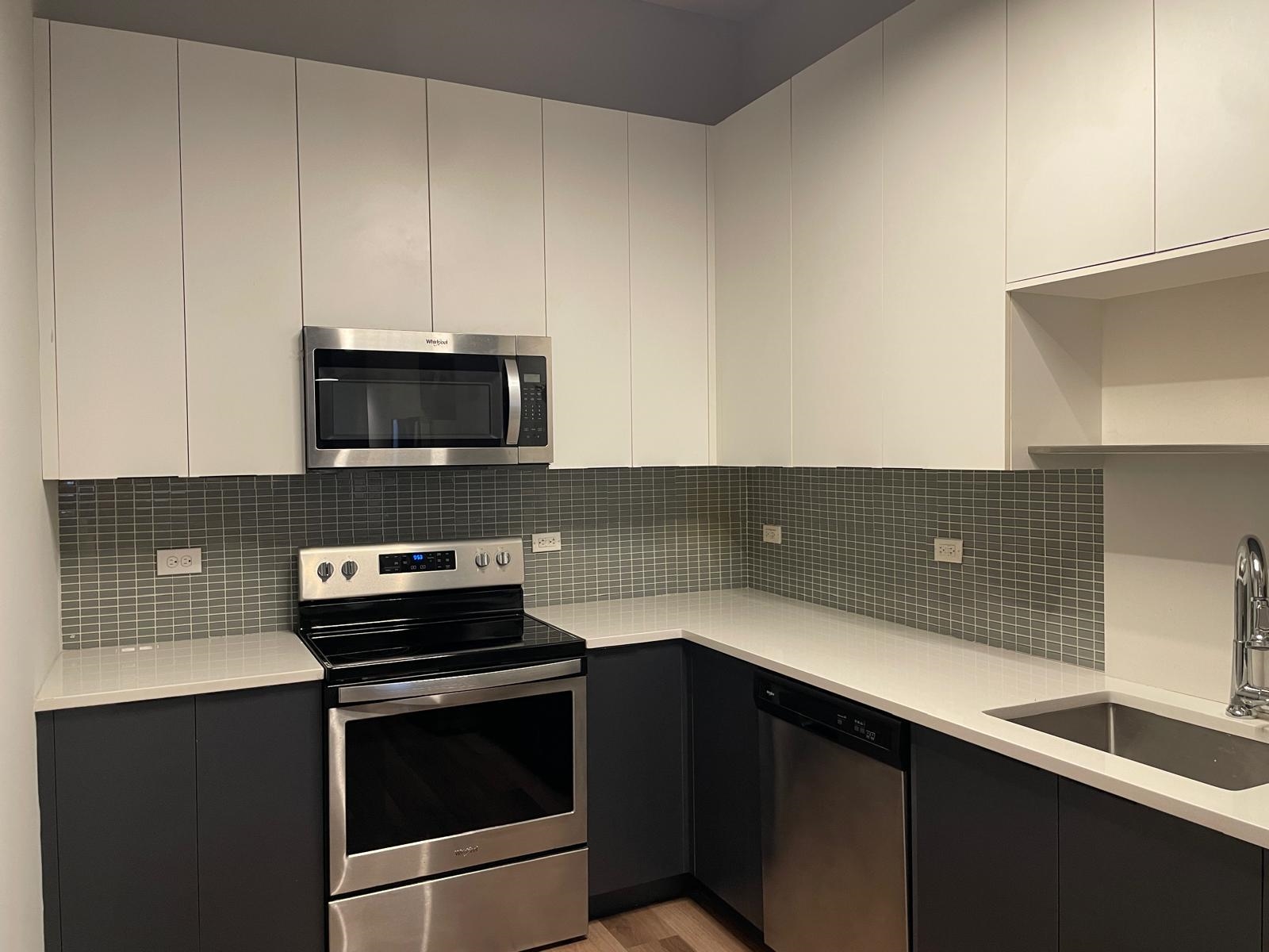 160 Lafayette Street, Unit 52207 Jersey City, NJ 07304 - Photo 6 of 25 a kitchen with a sink and a stove top oven