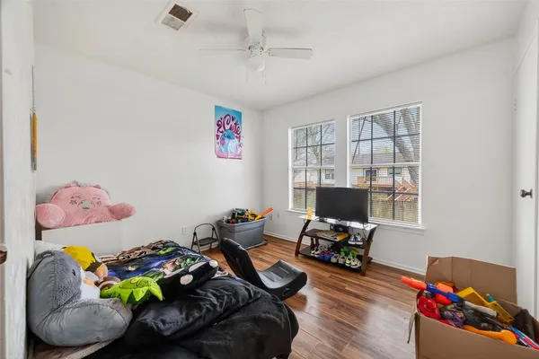 a living room with furniture and a wooden floor