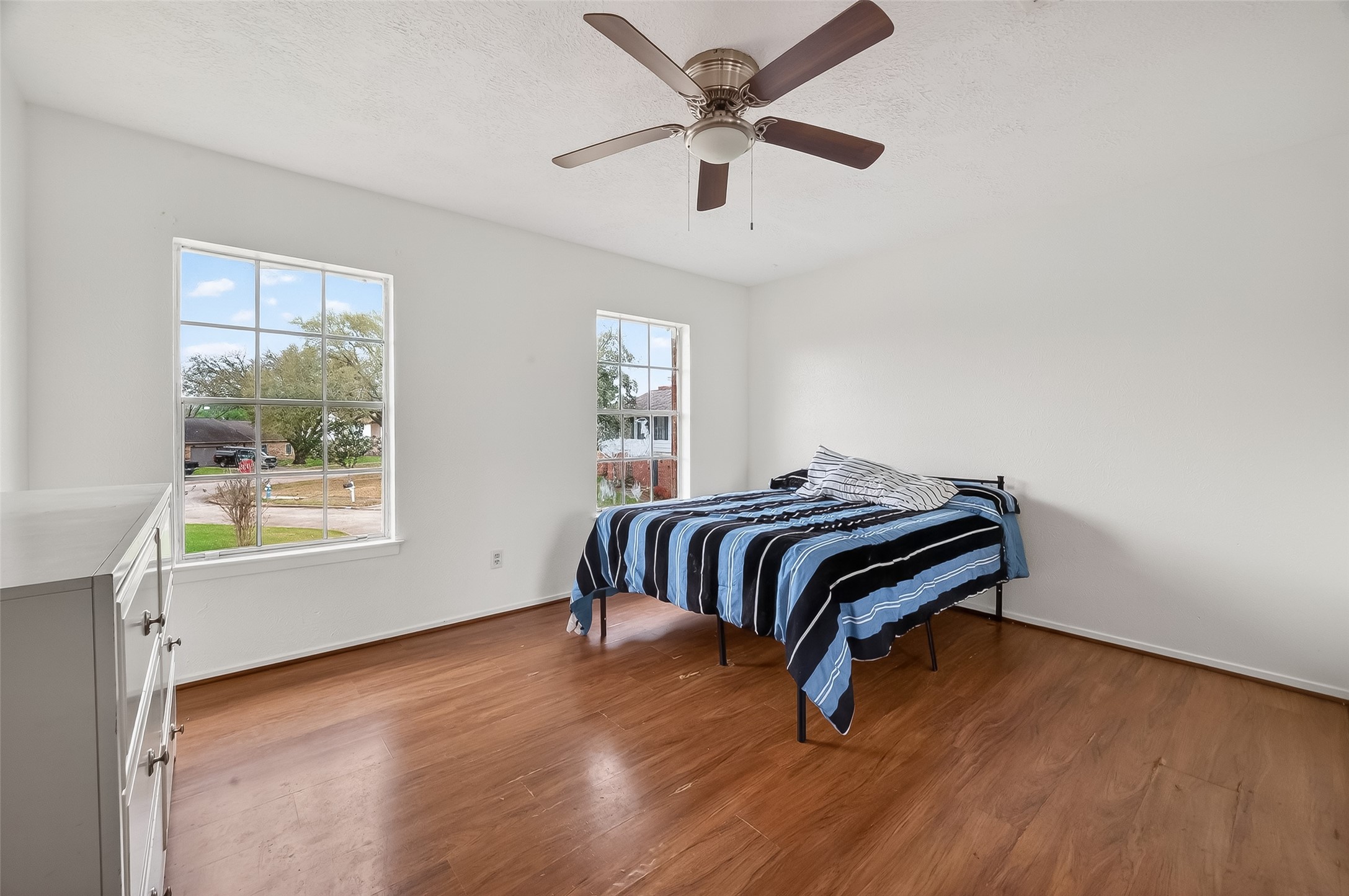 16006 El Toro Court Webster, TX 77598 - Photo 19 of 19 a bedroom with a bed and wooden floor