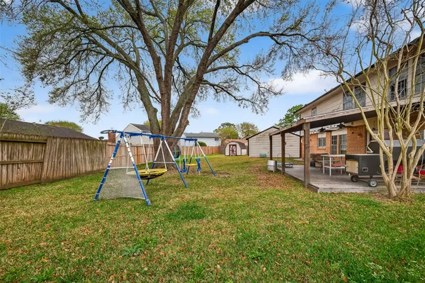 a kitchen with stainless steel appliances kitchen island granite countertop a refrigerator and a sink