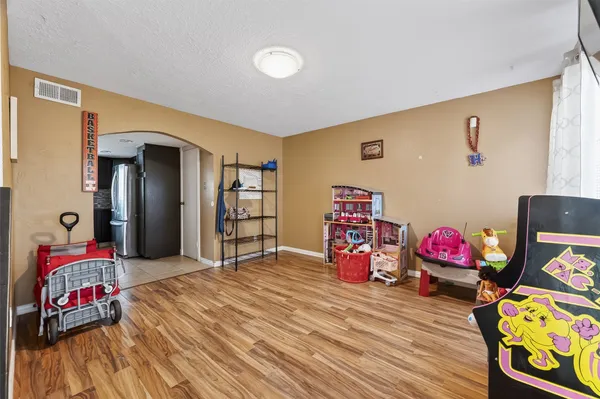 a view of a livingroom with workspace and a ceiling fan