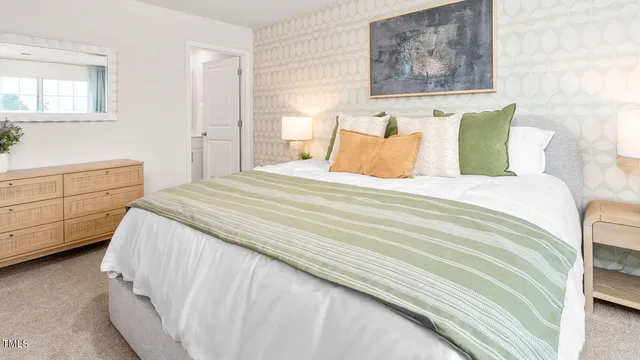 a bedroom with a bed and a painting on the wall