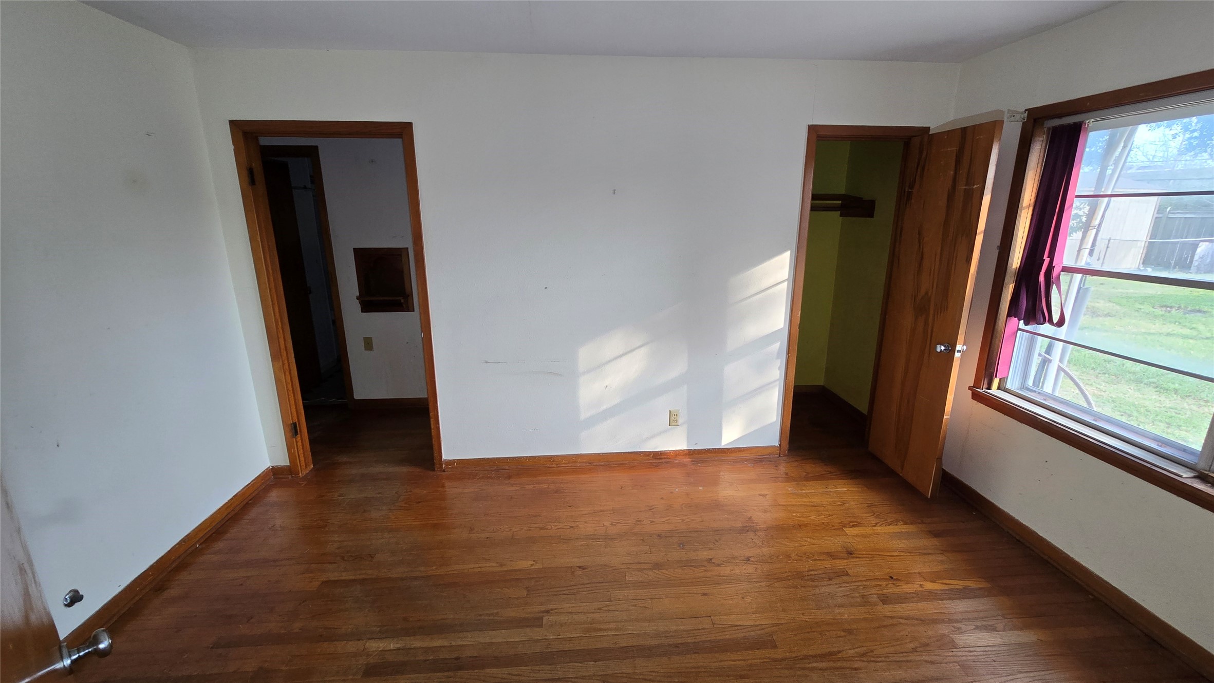 103 Long Drive Baytown, TX 77521 - Photo 14 of 21 a view of an empty room with wooden floor and a window