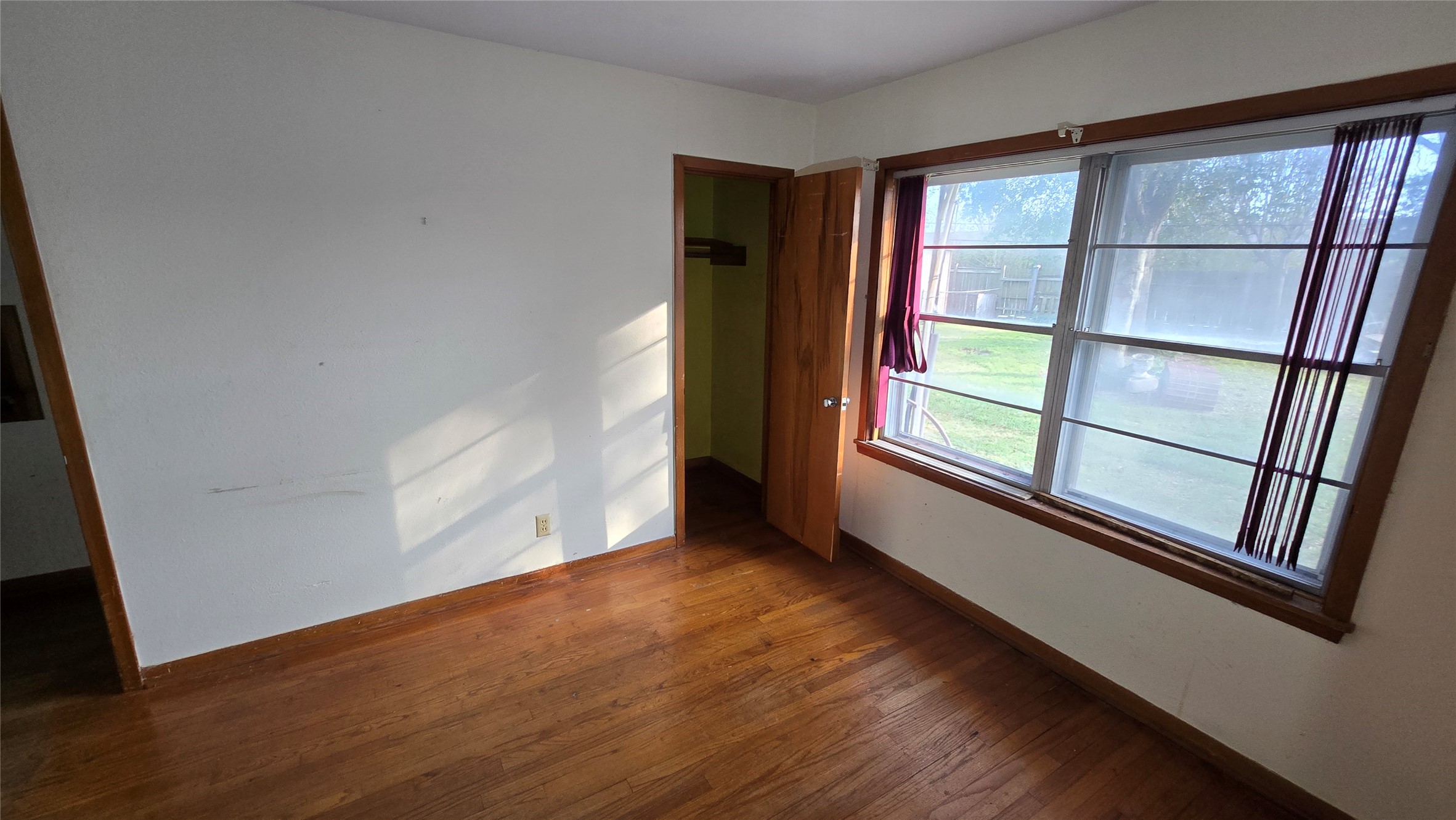 103 Long Drive Baytown, TX 77521 - Photo 15 of 21 an empty room with wooden floor and windows