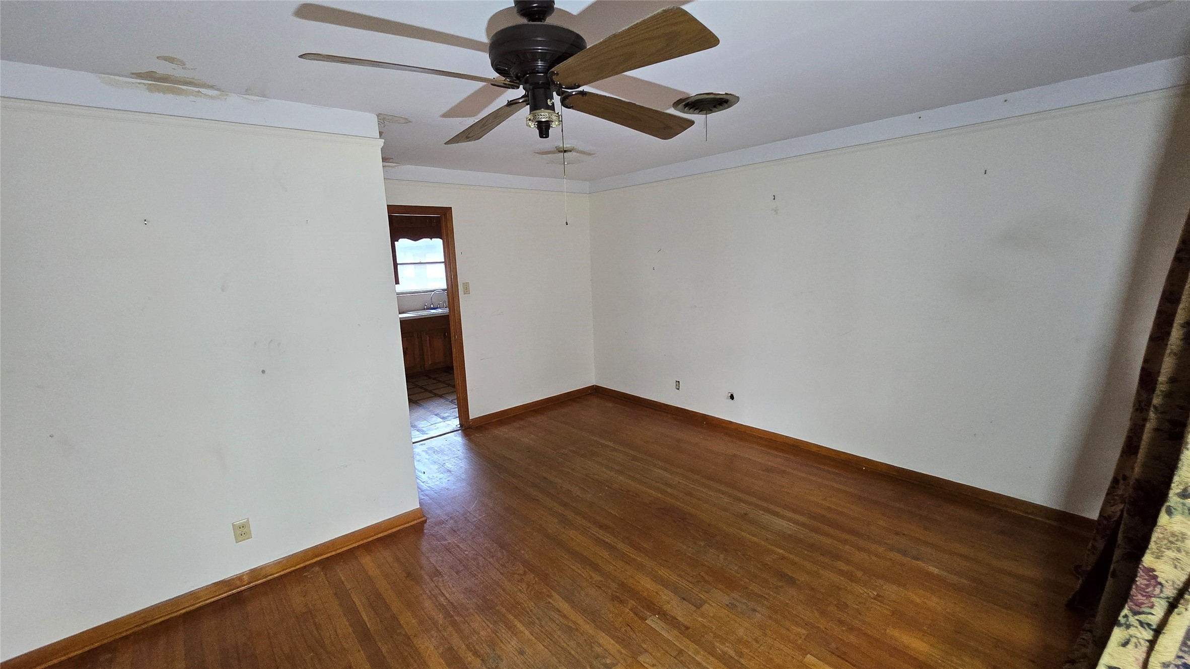 103 Long Drive Baytown, TX 77521 - Photo 5 of 21 a view of a room with wooden floor and ceiling fan