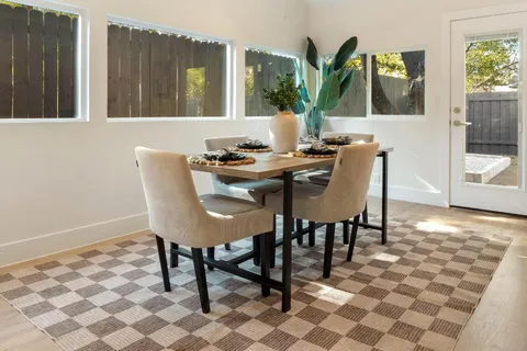 a view of a dining room with furniture and window