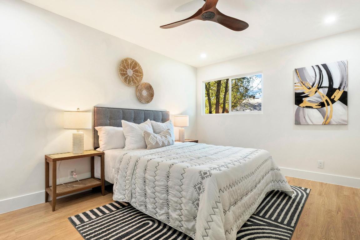 7010 Meadow Run Austin, TX 78745 - Photo 12 of 26 Bedroom featuring light wood-style floors and a ceiling fan