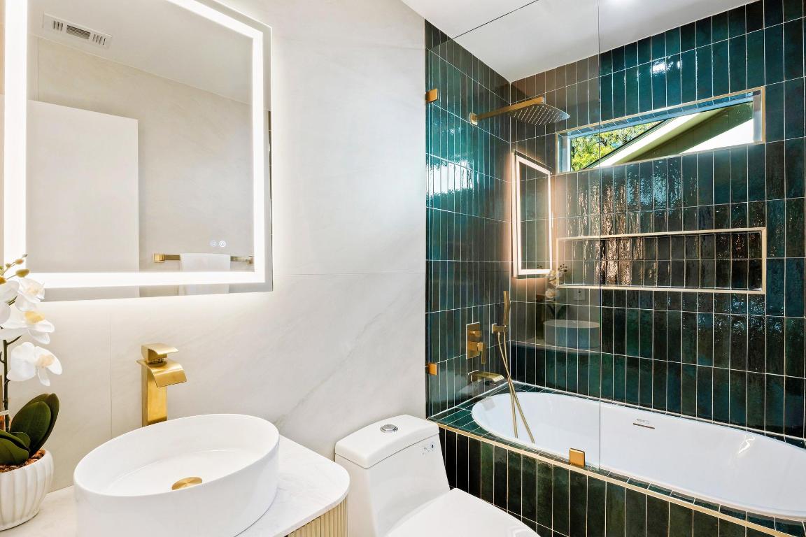 7010 Meadow Run Austin, TX 78745 - Photo 17 of 26 Bathroom with tiled shower / bath combo and vanity