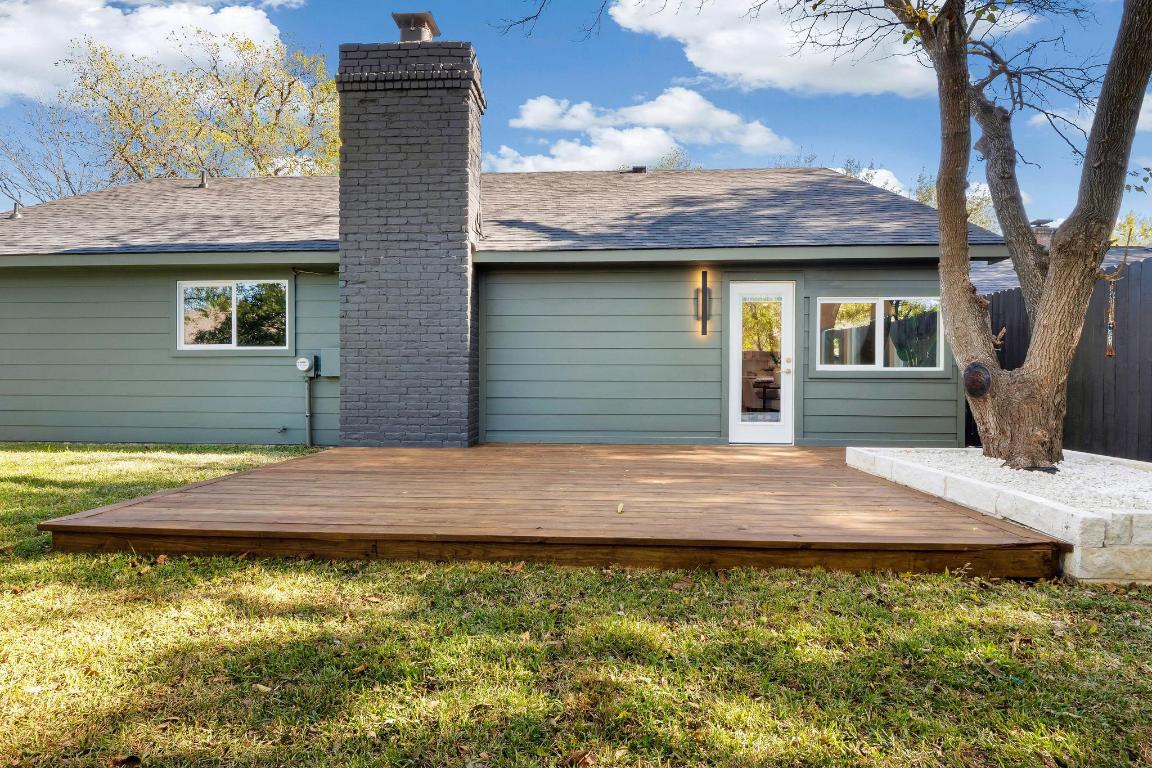 7010 Meadow Run Austin, TX 78745 - Photo 24 of 26 Rear view of property with a deck, a lawn, a chimney, and a shingled roof