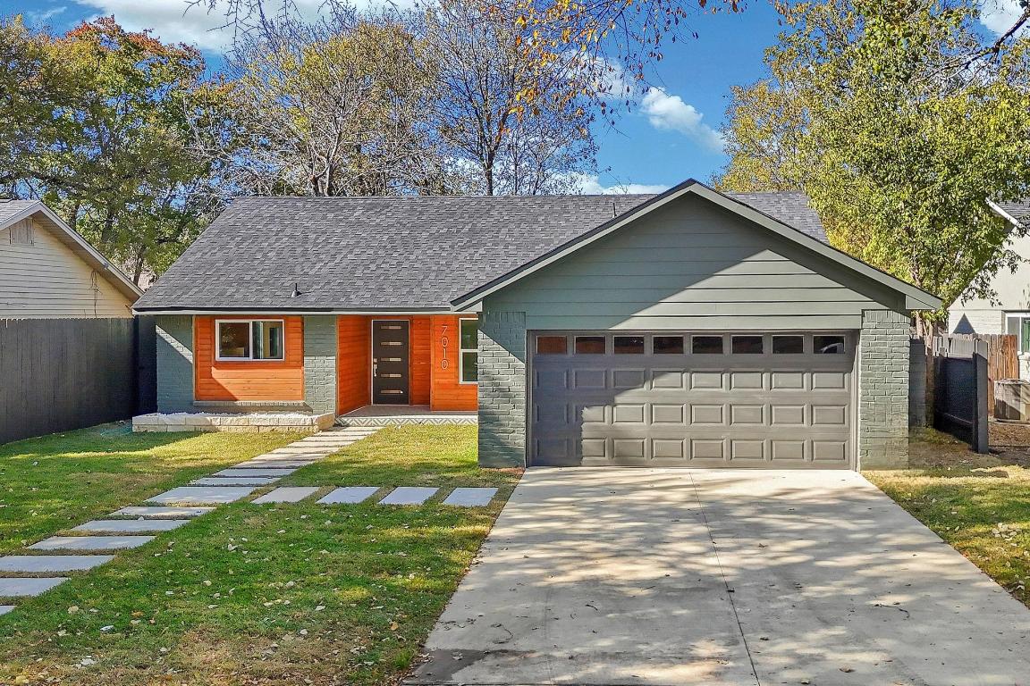 7010 Meadow Run Austin, TX 78745 - Photo 25 of 26 View of front facade with driveway, a garage, and roof with shingles