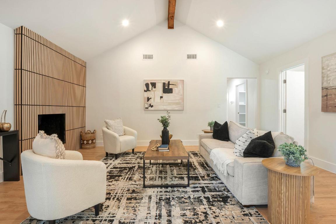 7010 Meadow Run Austin, TX 78745 - Photo 5 of 26 Living room with beamed ceiling, wood finished floors, and high vaulted ceiling