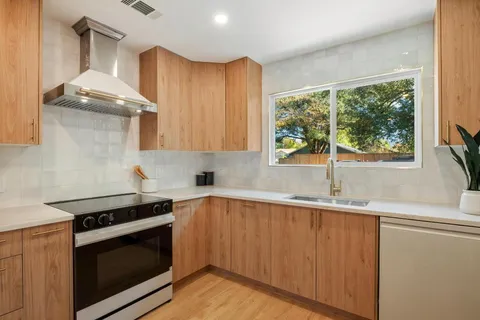 a kitchen with granite countertop a stove and a sink