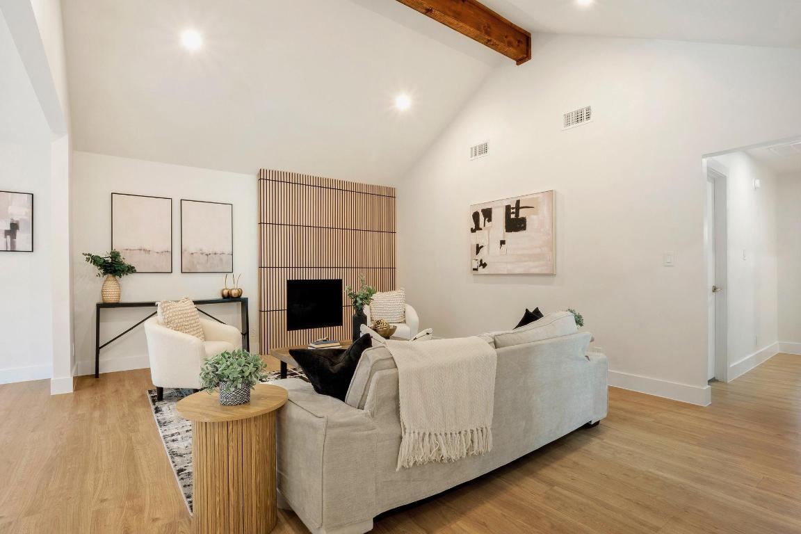 7010 Meadow Run Austin, TX 78745 - Photo 9 of 26 Living area featuring high vaulted ceiling, beam ceiling, recessed lighting, and light wood-style floors