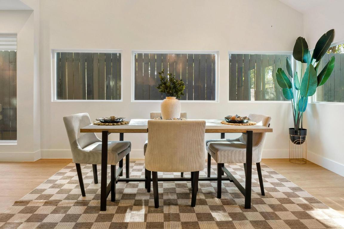7010 Meadow Run Austin, TX 78745 - Photo 10 of 26 Dining area featuring light wood-style flooring and baseboards