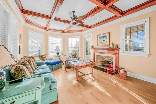 a living room with a baby crib furniture and a kitchen view