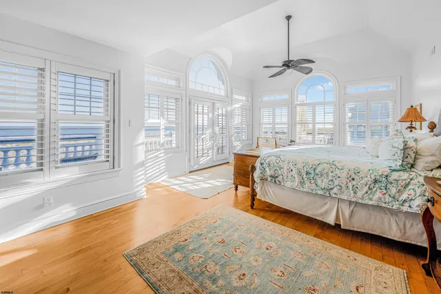 a large white room with mirror and a bathtub