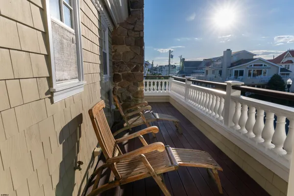 a view of a balcony with wooden floor