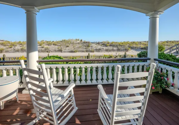 a balcony with furniture and a potted plant