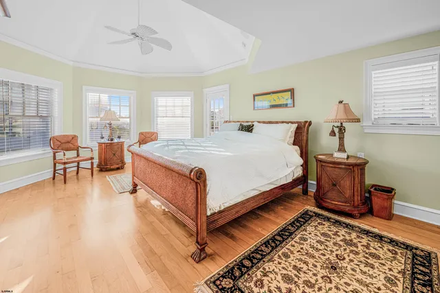 a bedroom with a bed a dresser and potted plants