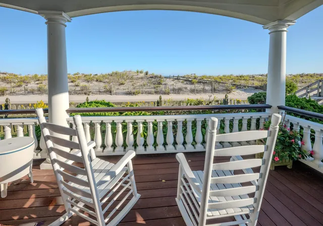 a view of a balcony with couch and wooden floor